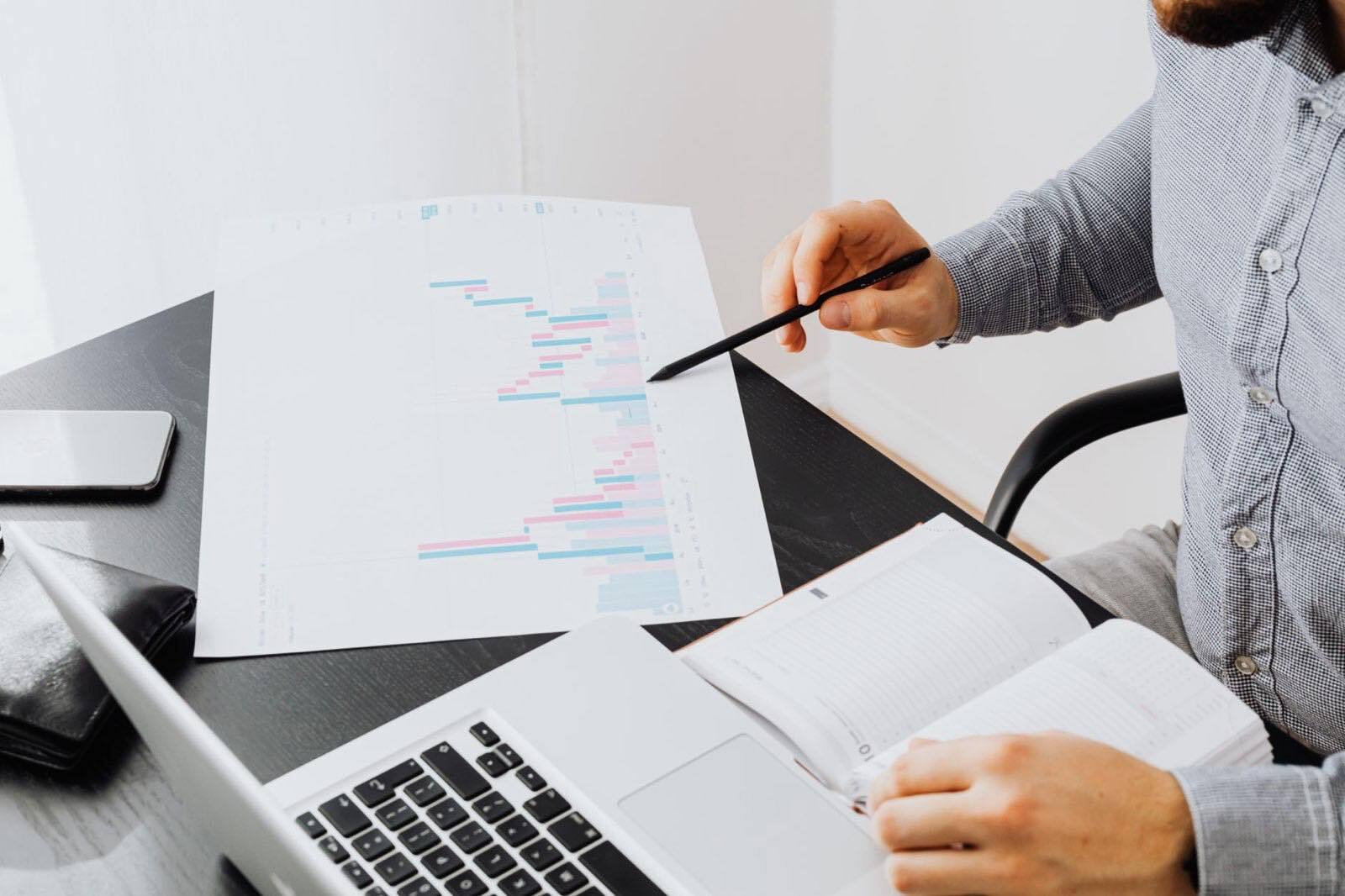 Stock photo by www.kaboompics.com via Pexels, illustrating technology executive reviewing dashboard laptop office (temporary placeholder pending custom hero design).