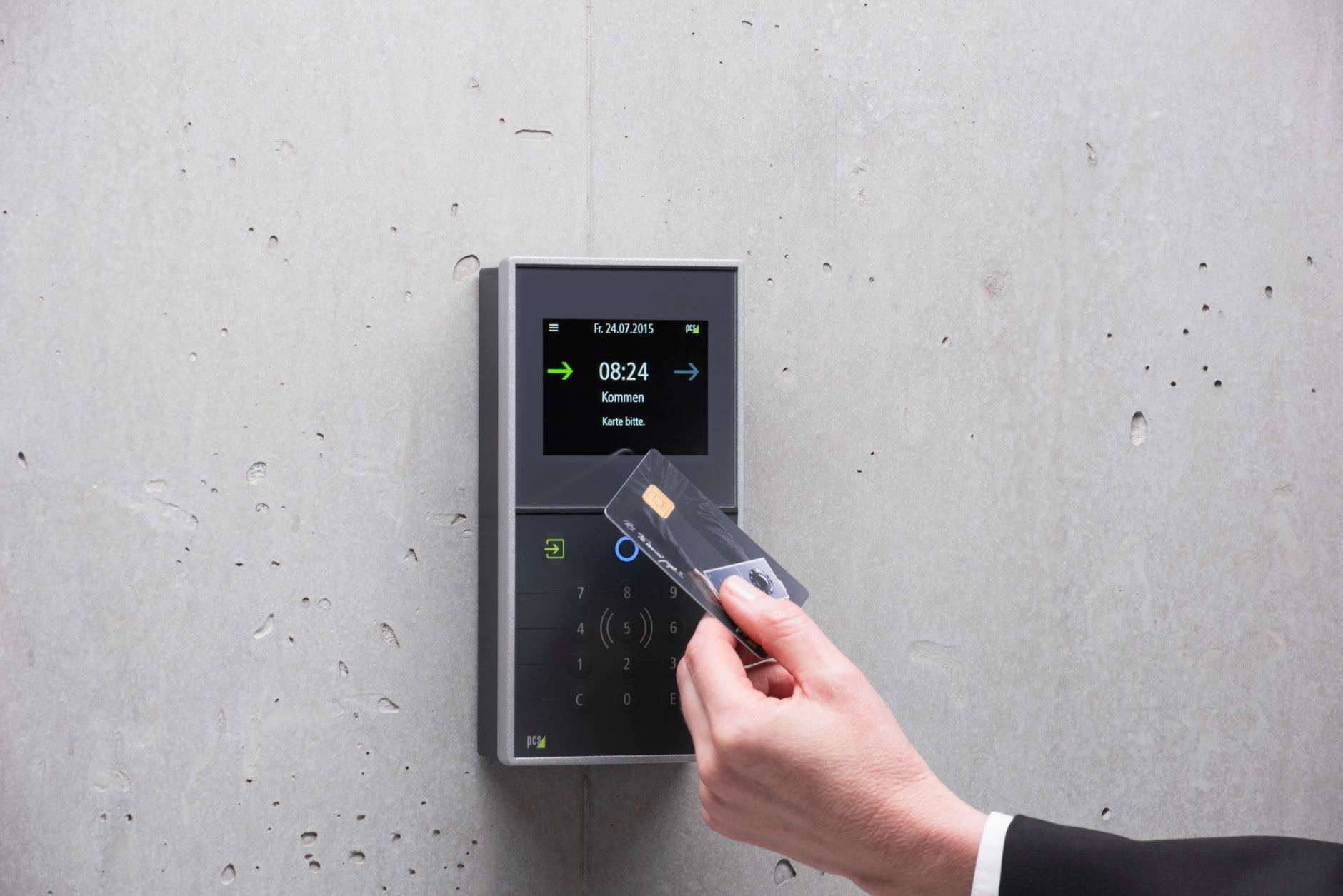 A businessman uses a secure card reader access system against a concrete wall, illustrating Phishing-Resistant MFA in Microsoft Entra ID: Rolling Out Passkeys to Thousands of Users
