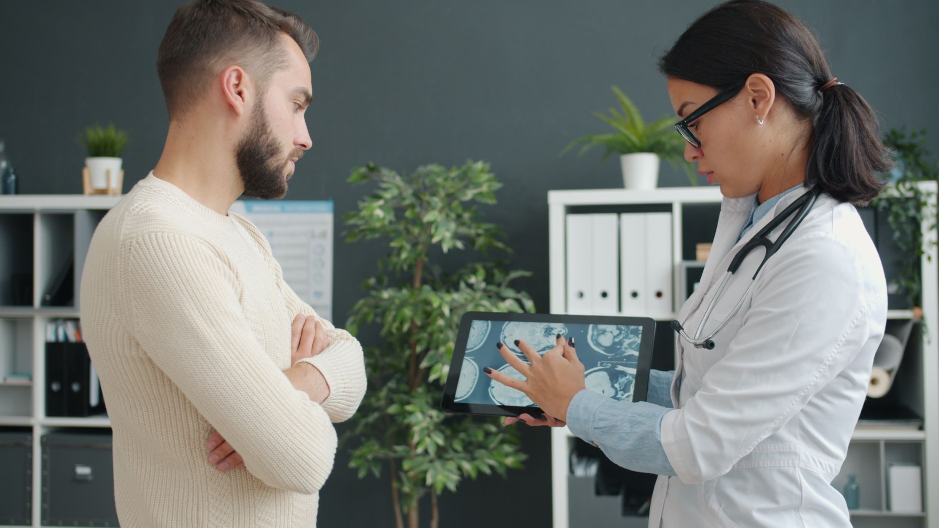 Clinician showing a patient health data on a tablet, for HIPAA in Canada