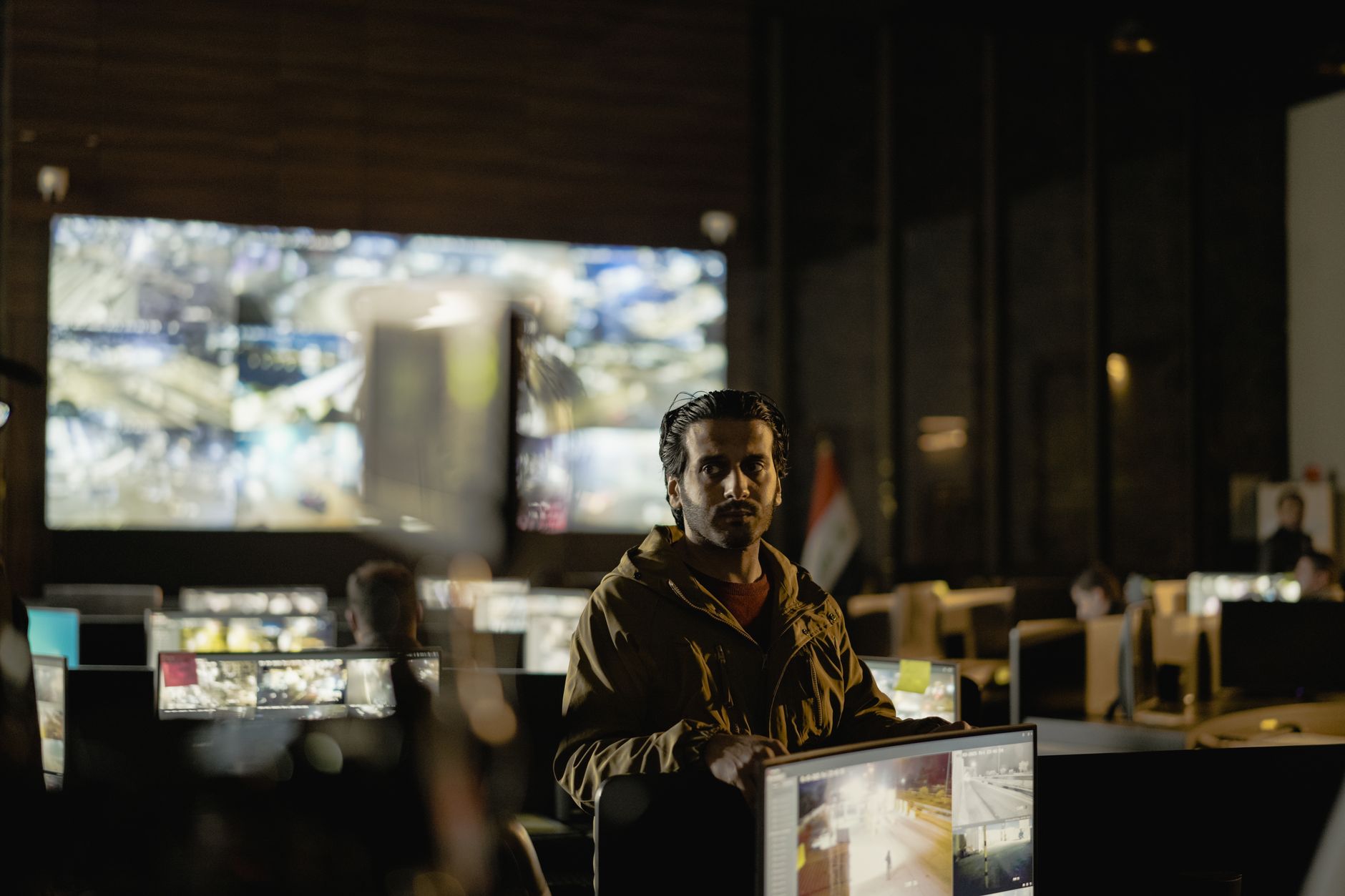 Modern security control room with a diverse team monitoring live surveillance feeds, illustrating Is Datadog a SIEM? How Datadog Cloud SIEM Handles SOC 2 Logging and Monitoring