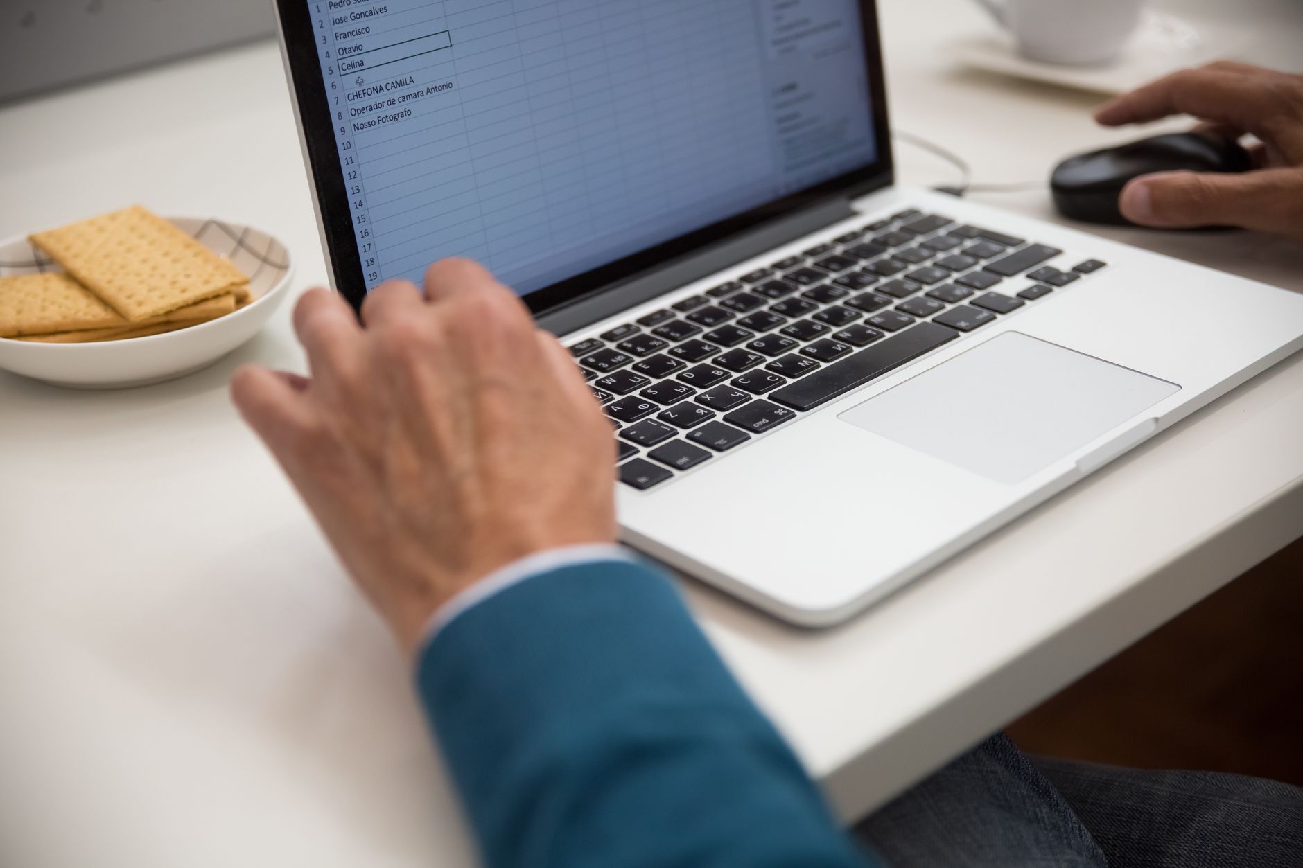 Laptop with a spreadsheet open, representing the ISO 27001 to SOC 2 control mapping sheet