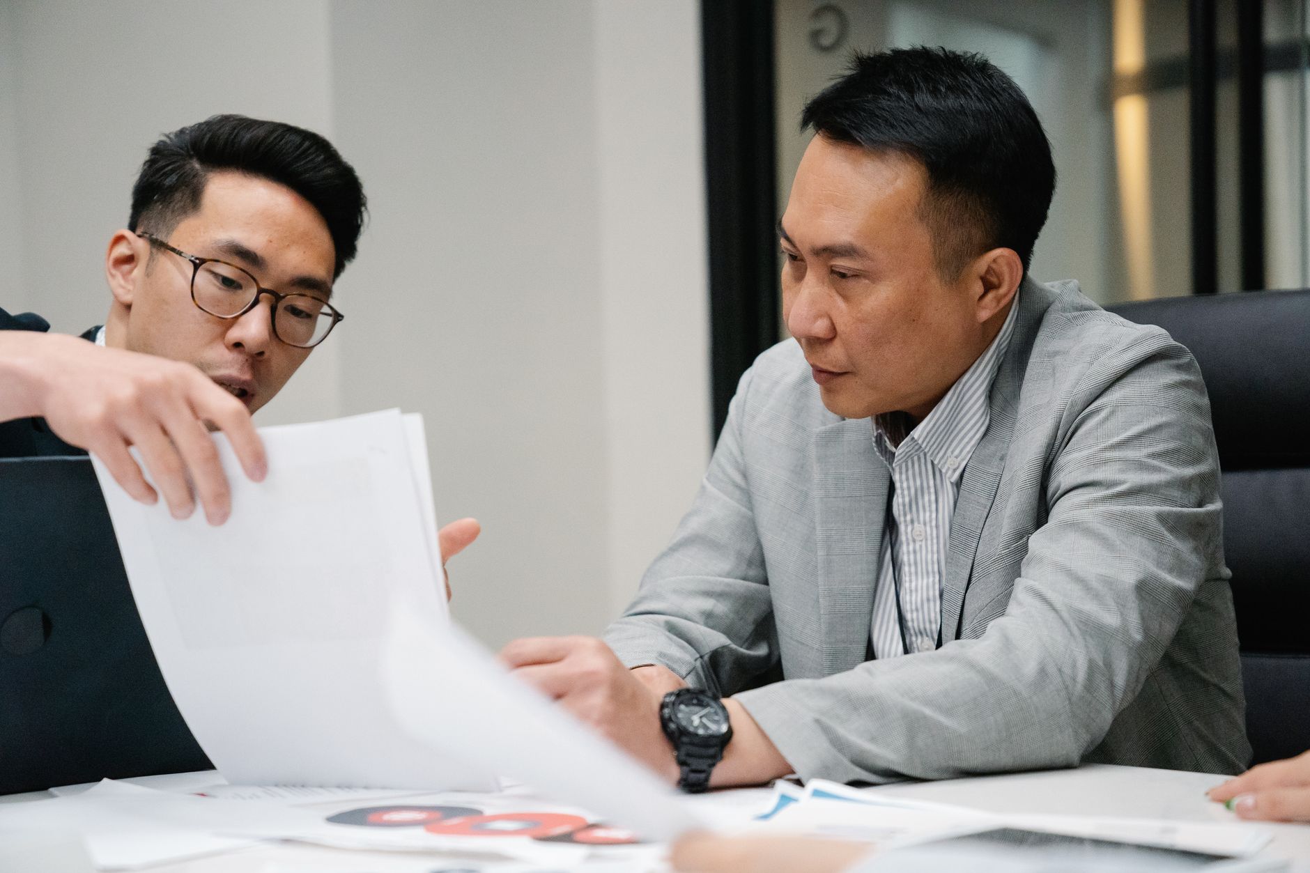 Stock photo by Felicity Tai via Pexels, illustrating two business professionals comparing documents meeting (temporary placeholder pending custom hero design).
