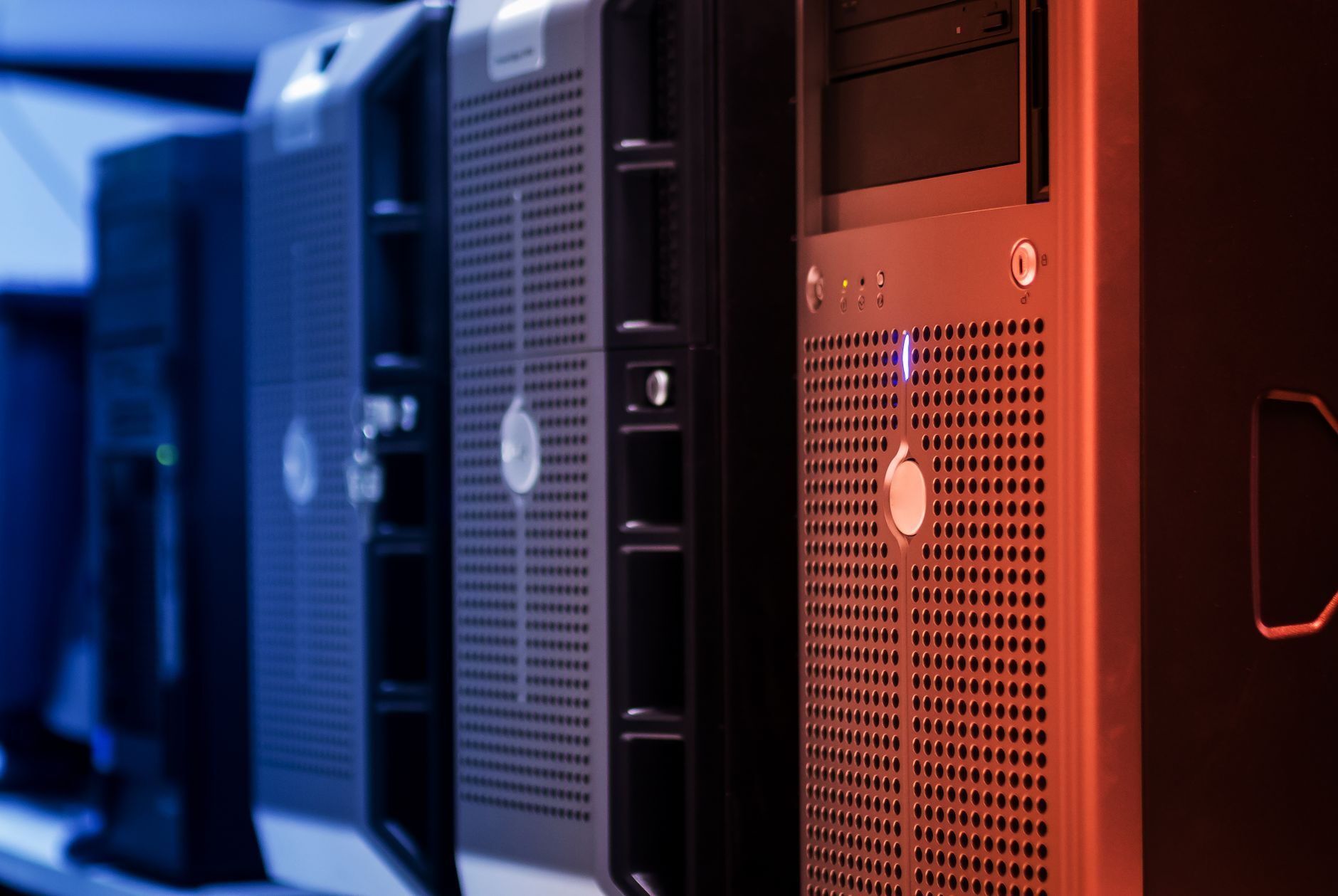 Close-up of tower servers in a data center with blue and red lighting, illustrating SOC 2 Availability Without a Second Data Center: Meeting A1 on a Single Site