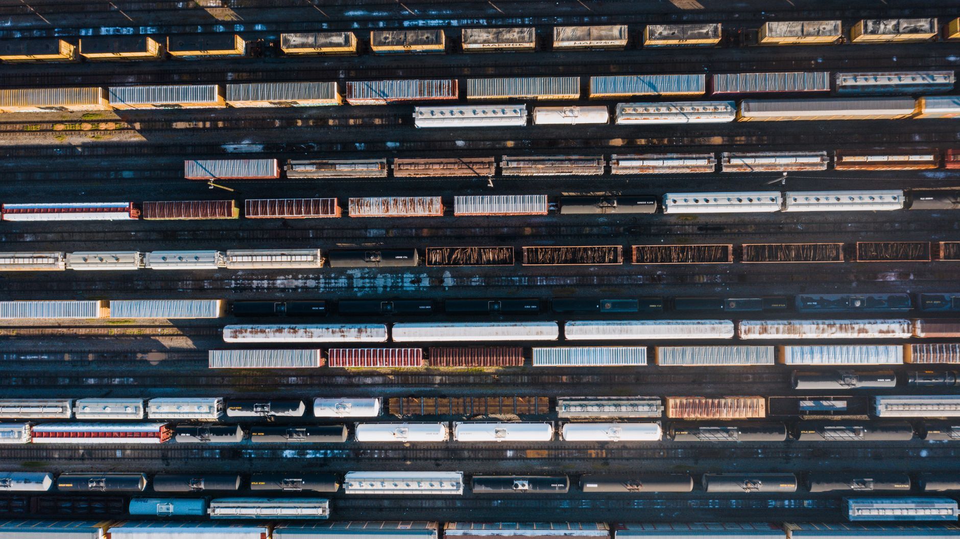 Aerial view of rows of rail freight cars in a rail yard, illustrating supply chain and third-party risk