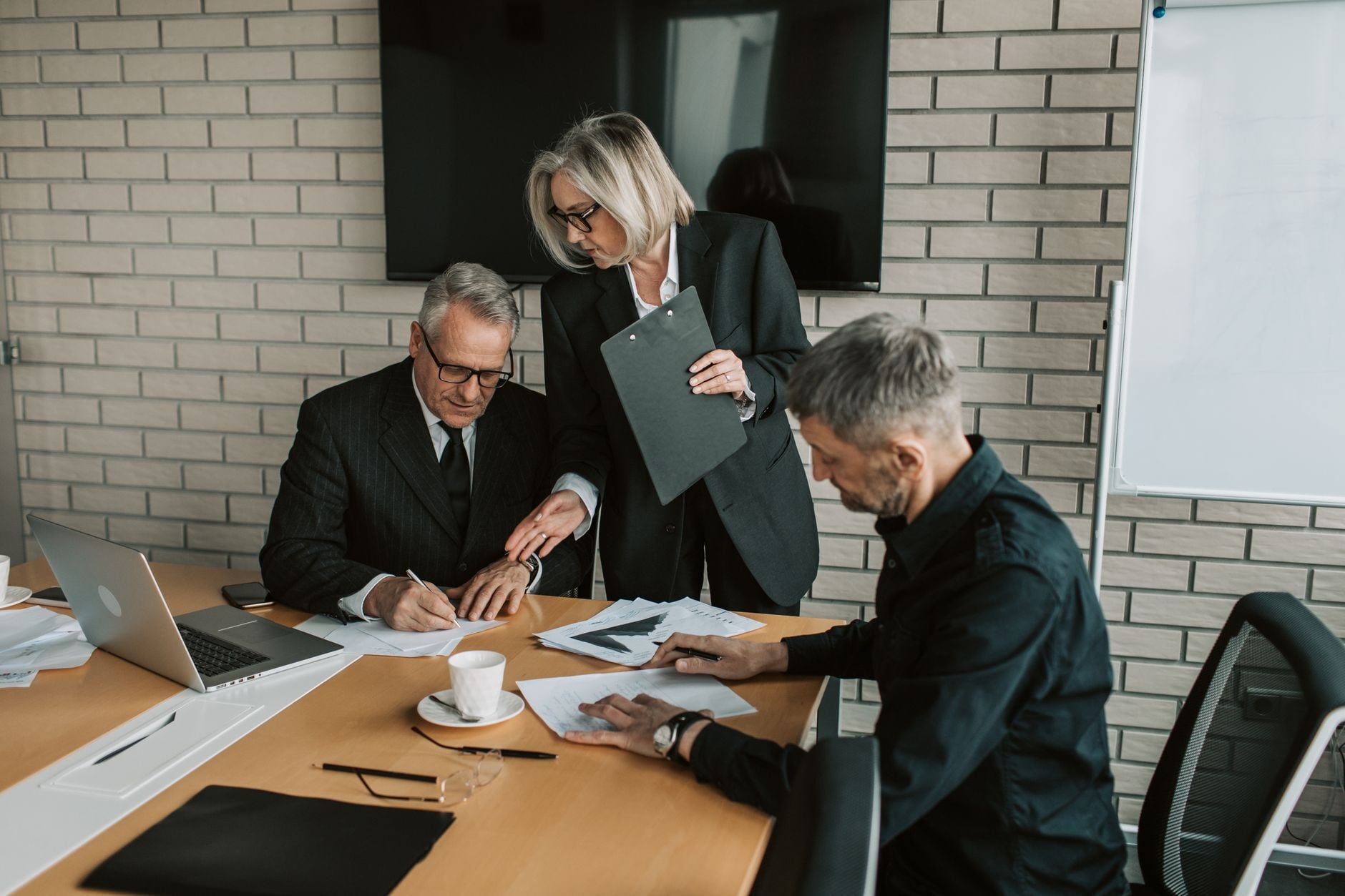 Security leadership team reviewing documents in a boardroom meeting