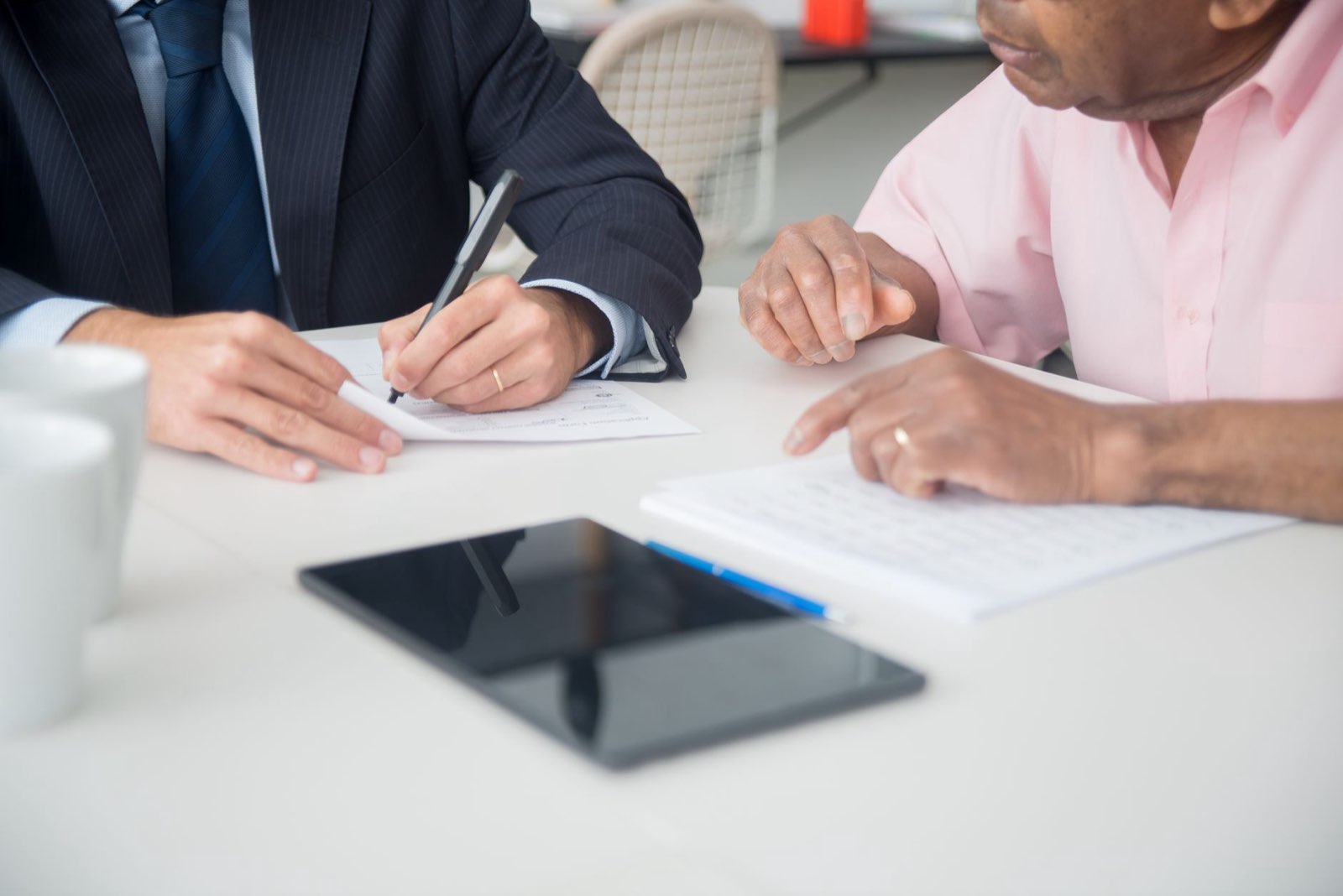 Stock photo by Kampus Production via Pexels, illustrating two business people signing contract agreement office (temporary placeholder pending custom hero design).