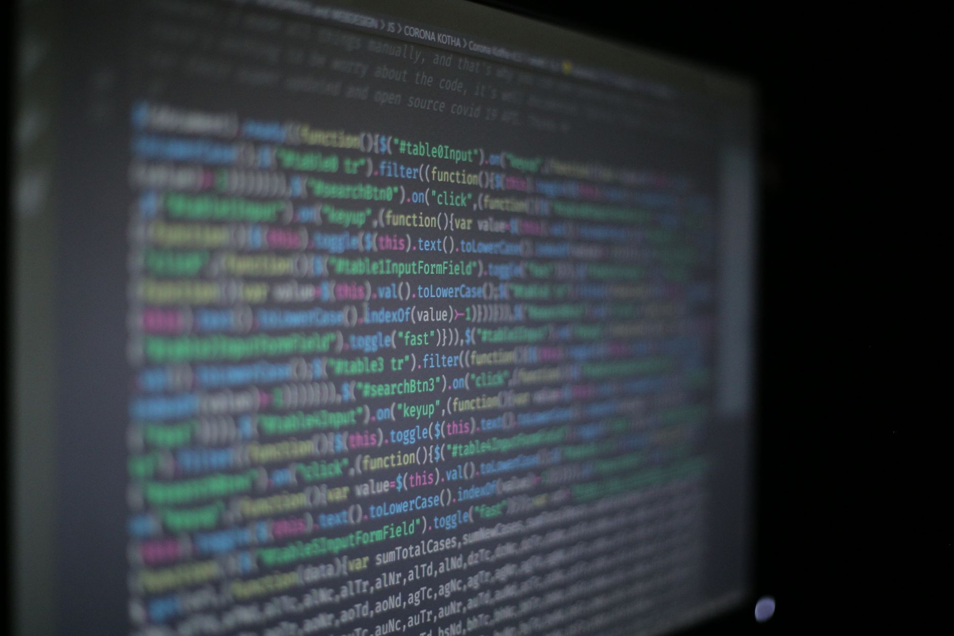 Close-up of colorful programming code on a blurred computer monitor, illustrating What Is Prompt Injection? Direct vs. Indirect Attacks, Explained